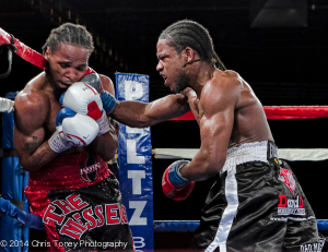 Nelson (R.) pinning Rodriguez to the ropes with a right.